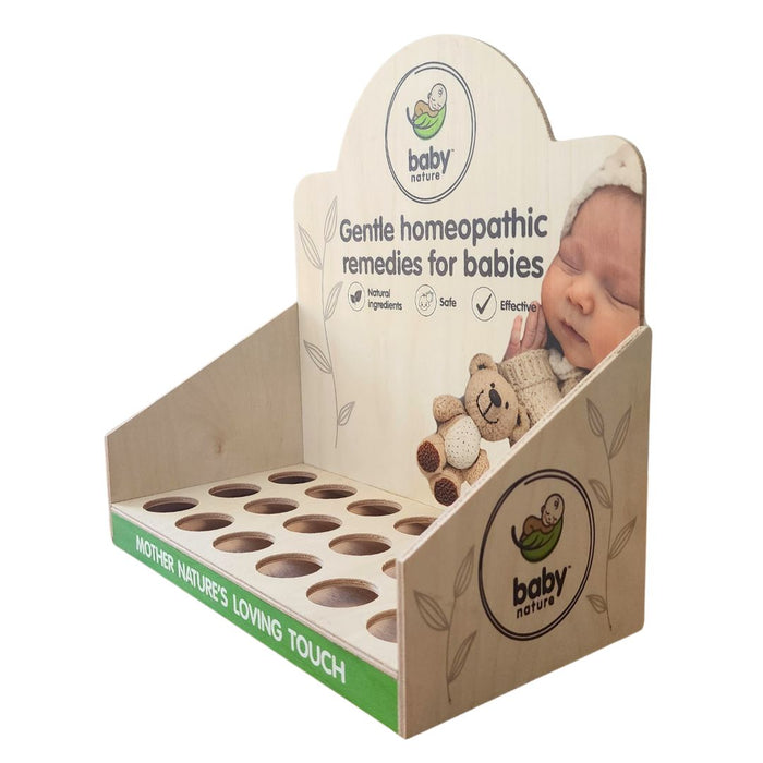 BabyNature wooden countertop display rack with circular bottle slots, printed branding, and soothing baby-themed graphic